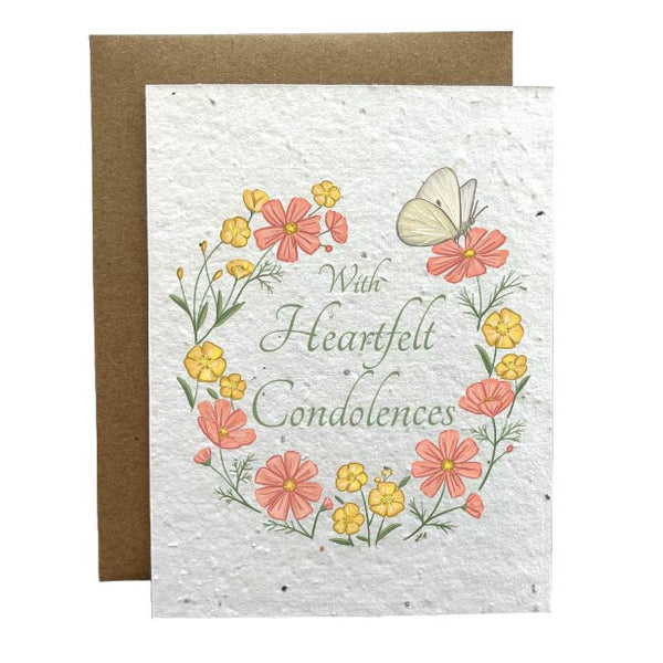 With heartfelt condolences plantable greeting card. A flower wreath with pink and yellow flowers with a butterfly. "With Heartfelt Condolences" is written in the middle of the card.