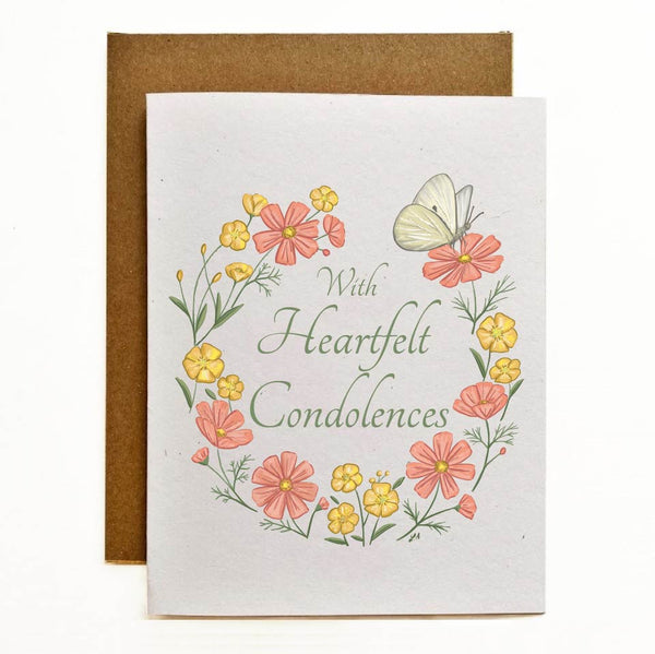 With heartfelt condolences recycled cardstock greeting card. A flower wreath with pink and yellow flowers with a butterfly. "With Heartfelt Condolences" is written in the middle of the card.